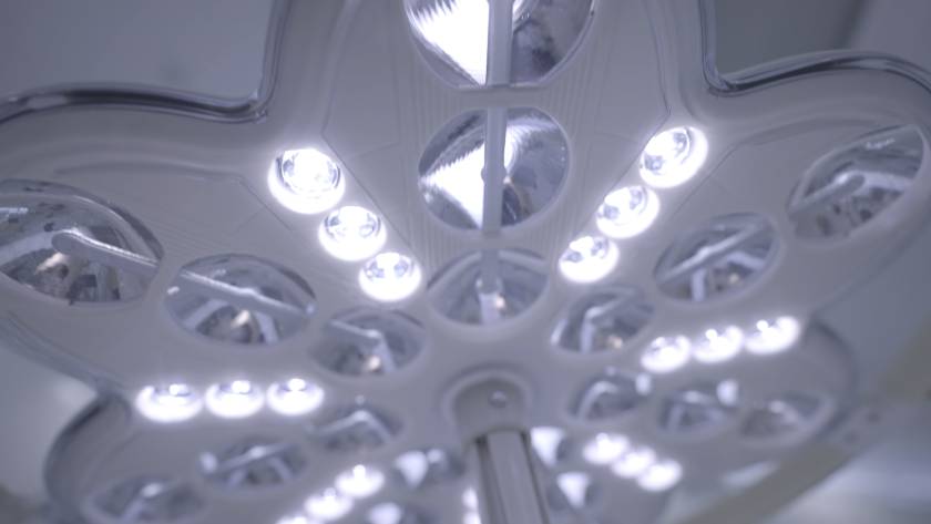 A bright flower-shaped lamp. Action. A glowing bright chandelier in the shape of a mysterious flower shines brightly directly into the camera.