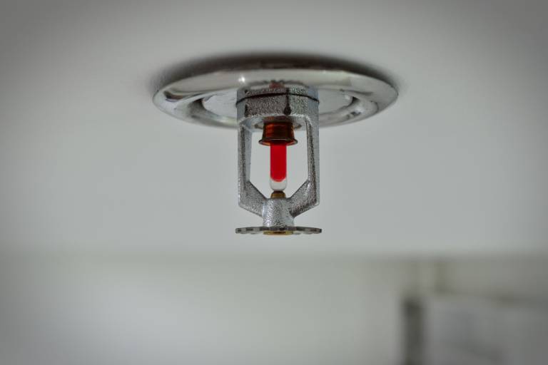 Closeup shot of an emergency fire sprinkler on a house ceiling