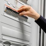 Electric Consultant Checking Fuse In Server Room