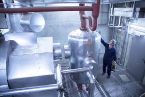 Elevated view of engineer inspecting machinery in power station