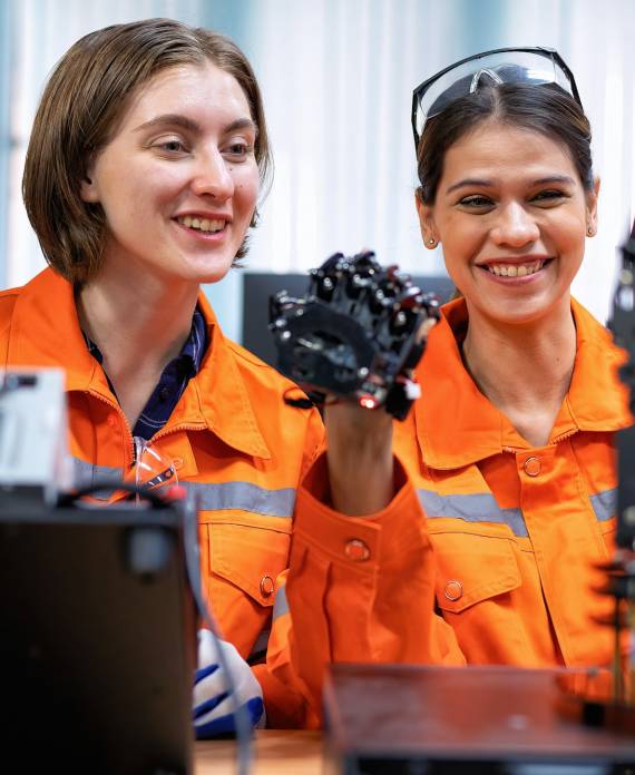 Girl engineer in robot industry fabrication research room simulate testing robot arm on operation