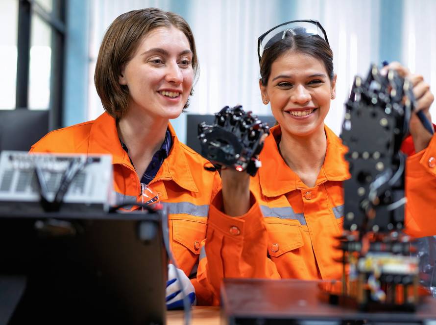 Girl engineer in robot industry fabrication research room simulate testing robot arm on operation