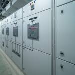 Interior of electrical room. Power energy motor machinery cabinets in control or server room, main operator station network and circuit center in industry factory manufacturing system. generator