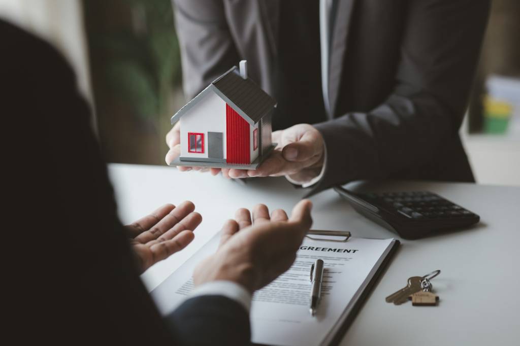 Real estate agents are holding a housing model of the project.